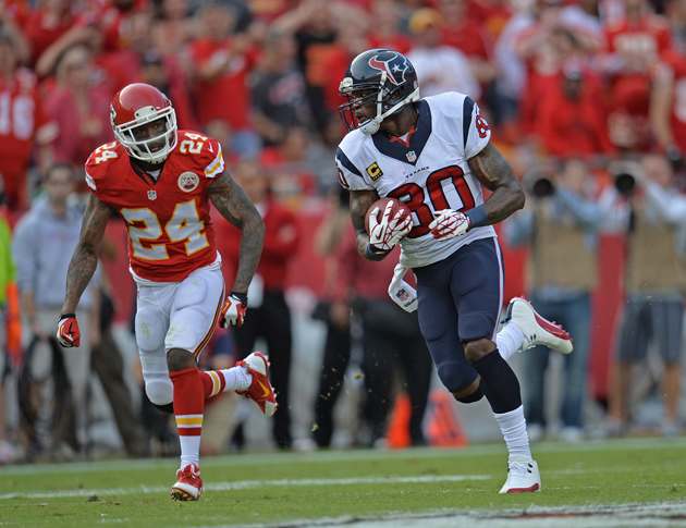 Wide receiver Andre Johnson rushes up field while defensive back Brandon Flowers trails behind him looking for a tackle.